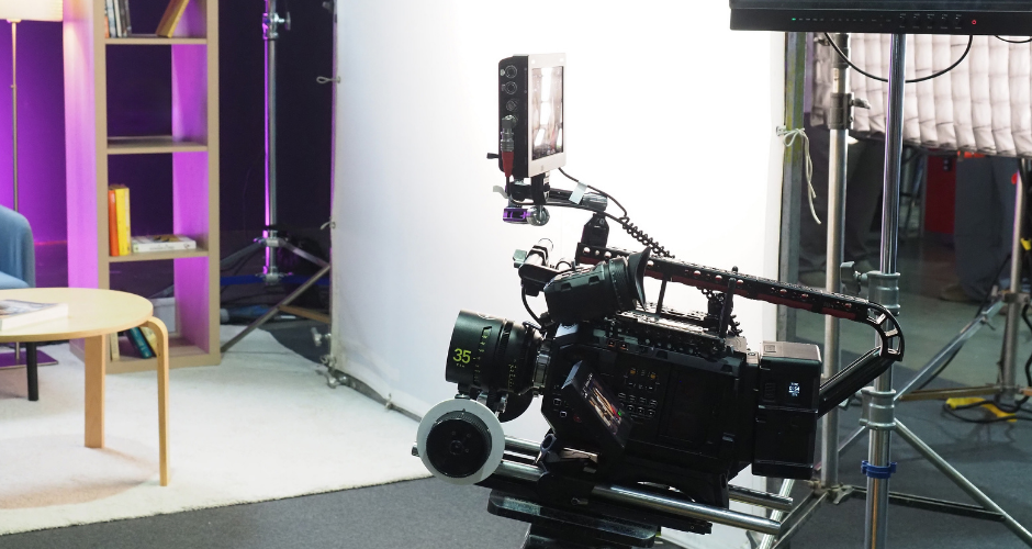 Professional video camera setup on a slider in a studio with soft lighting, ready for a brand video production shoot.